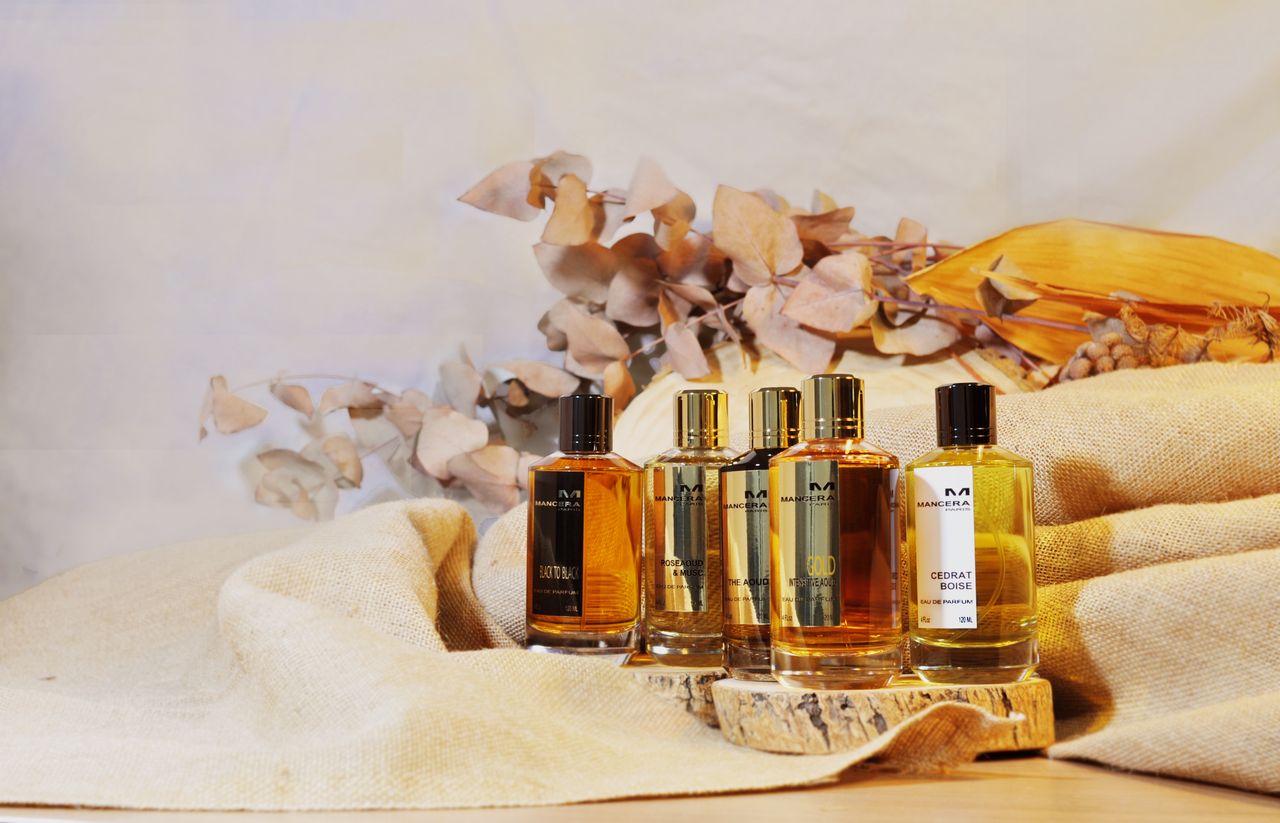 About Aesthetic display of luxury perfume bottles with natural dried botanicals and linen backdrop.